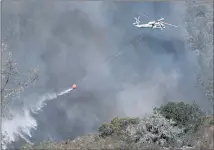  ?? JOSE CARLOS FAJARDO — STAFF ARCHIVES ?? A helicopter drops water while battling the Glass Fire in St. Helena on Sept. 27, 2020. Jet fuel shortages could hamper firefighti­ng during a busy wildfire season in the western United States.