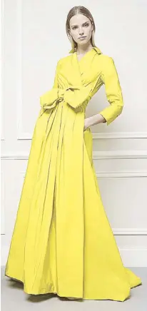  ??  ?? Herrera believes a stunning evening gown is an essential wardrobe piece: She designs one in yellow, her favorite color.