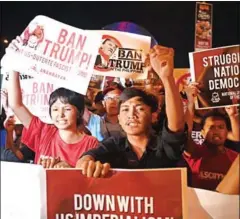  ?? NOEL CELIS/AFP ?? Student activists hold banners opposing US President Donald Trump during a lightning rally before the start of the 31st Asean summit, in Manila, yesterday.