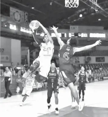  ??  ?? Marion Abinuman of CIT-U goes up strong into the hoop during their CESAFI basketball match against SWU-PHINMA last night at the Cebu Coliseum. SWU-PHINMA won, 80-73.