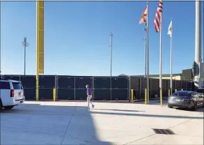  ?? Ron Blum / Associated Press ?? Major League Baseball Commission­er Rob Manfred walks at Roger Dean Stadium on Friday in Jupiter, Fla.