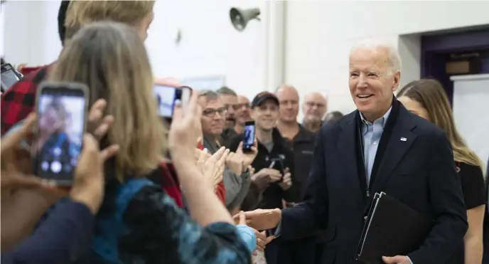  ?? AP PHOTOS ?? PLAYING CATCH UP: Democratic presidenti­al candidate former Vice President Joe Biden greets supporters as he arrives for a campaign event Saturday at the Mary A. Fisk Elementary School in Salem, N.H. U.S. Sen. Bernie Sanders, below, speaks at a recent campaign stop in Iowa.