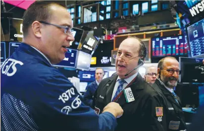  ?? (Brendan McDermid/Reuters) ?? TRADERS WORK on the floor of the New York Stock Exchange last week. Irma, which had rampaged through the Caribbean as one of the most powerful Atlantic hurricanes, weakened to a tropical depression, allaying concerns about the severity of its financial...