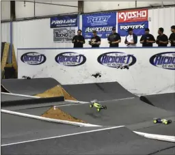  ??  ?? Racers navigate their RC cars through the jumps and sharp turns of the Ricochet R/C Raceway on Sunday during a heat of the 4th annual Pro-Line Carpet Classic Imperial. PHOTO TOM BODUS in