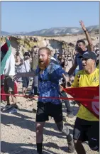  ?? THE SNAPSHOT PEOPLE LTD — THE ASSOCIATED PRESS ?? British runner Russ Cook arrives to the finish line in Ras Angela, the most northern point of the African continent, in Tunis, Tunisia, on Sunday to complet his incredible journey.