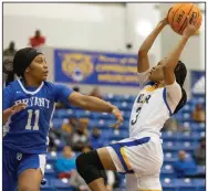  ?? (Arkansas Democrat-Gazette/Justin Cunningham) ?? North Little Rock’s Arin Freeman (right) goes up for a shot in front of Bryant’s India Atkins (11) during the Lady Charging Wildcats’ 6352 victory over the Lady Hornets on Tuesday in North Little Rock.