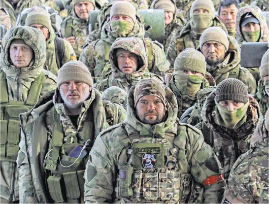  ?? ?? Volunteers, who joined the Russian armed forces and were trained in Chechnya, board a plane in Grozny before departing for positions in Ukraine