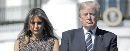  ?? Pablo Martinez Monsivais ?? The Associated Press President Donald Trump and first lady Melania Trump observe a moment of silence Monday at the White House to remember the victims of Sunday’s mass shooting in Las Vegas.