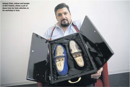  ??  ?? Antonio Vietri, artisan and founder of A& V Fashion, shows a pair of shoes from his Gold collection, in his workshop in Turin.