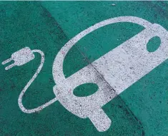  ?? — Reuters file photo ?? A sign is pictured on an electric car charging station at the United Nations in Geneva.