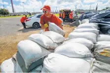  ?? Matthew Hinton / Associated Press ?? Inmate workers move sandbags in Chalmette, La., before Tropical Storm Barry is set to move in from the Gulf of Mexico.