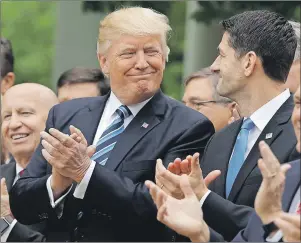  ?? "1 1)050 ?? U.S. President Donald Trump talks with House Speaker Paul Ryan of Wis., in the Rose Garden of the White House in Washington Thursday after the House pushed through a health care bill.