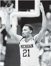  ?? Gregory Shamus / Getty Images ?? Zak Irvin signals a 3-pointer after hitting the key shot for Michigan late in Wednesday’s victory over Tulsa.