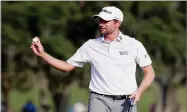  ?? AP PHOTO BY LYNNE SLADKY ?? Webb Simpson holds up his ball on the 18th green during the second round of The Players Championsh­ip golf tournament Friday, May 11, in Ponte Vedra Beach, Fla.