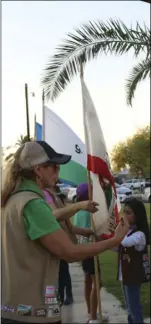  ??  ?? Belia Garneau (left), Troop 7036 leader, drills girl scouts during the 100th anniversar­y of Girl Scouts San Diego in Eager Park, on Saturday. WILLIAM ROLLER PHOTO