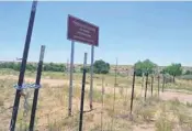  ??  ?? A barbed wire fence abuts the traditiona­l village of La Bajada, warning trespasser­s against entering land belonging to Cochiti Pueblo. A village resident, Alonzo Gallegos, said the village’s water source is situated on the other side of the fence, and...