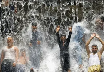  ?? (Arif Ali/AFP via Getty Images/TNS) ?? PAKISTANIS CROWD a water park to beat the heat in Lahore in this undated picture.