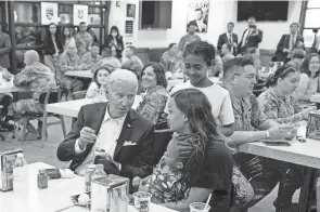  ?? EVAN VUCCI/AP ?? President Joe Biden talks with the family of a U.S. service member at Osan Air Base in Pyeongtaek, South Korea, on Sunday.