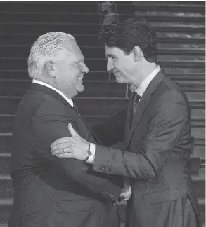  ?? CHRIS YOUNG / THE CANADIAN PRESS ?? Premier Doug Ford greets Prime Minister Justin Trudeau at the Ontario Legislatur­e.