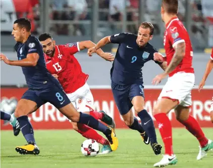  ?? Photo: Domenic Aquilina ?? England’s Harry Kane (R) evades the challenge of Zach Muscat (L) and Andrei Agius (C) during yesterday’s Qorld Cup qualifier at Ta’ Qali