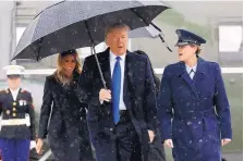  ?? EVAN VANUCCI/ASSOCIATED PRESS ?? President Donald Trump and first lady Melania Trump walk to board Air Force One for a trip to London to attend the NATO Summit on Monday.