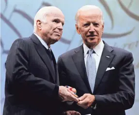  ?? MATT ROURKE/AP ?? Joe Biden presents the Liberty Medal to John McCain on Oct. 16, 2017. The men were opponents politicall­y but friends personally.