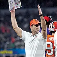  ?? AP/JEFFREY MCWHORTER ?? Clemson Coach Dabo Swinney signals to his team in the first half of the Cotton Bowl against Notre Dame on Saturday in Arlington, Texas. Swinney has made good on his word to lead the Tigers to their winningest decade.