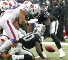  ?? JEFFREY T. BARNES, THE ASSOCIATED PRESS ?? Oakland Raiders’ Jalen Richard, bottom, fumbles a punt return in Sunday’s game in Buffalo, in which the Bills won 34-14.