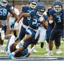  ?? MIKE CAUDILL/FREELANCE ?? Old Dominion running back Keshawn Wicks breaks a tackle during the Priority Charity Bowl ODU Spring Game on Saturday at S.B. Ballard Stadium.