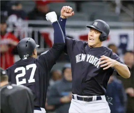  ?? THE ASSOCIATED PRESS ?? New York Yankees Giancario Stanton, left, celebrates his two-run home run with teammate Aaron Judge after both scored during the third inning of a spring training baseball game against the Atlanta Braves, Monday in Atlanta.