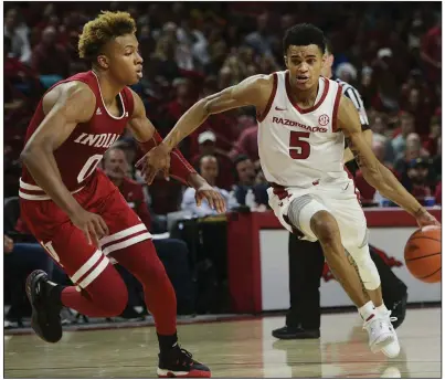  ?? NWA Democrat-Gazette/CHARLIE KAIJO ?? Indiana freshman guard Romeo Langford (left) guards Arkansas sophomore guard Jalen Harris during the Razorbacks’ victory over the Hoosiers on Nov. 18 at Walton Arena in Fayettevil­le. The teams play again Saturday in a second-round NIT game at Bloomingto­n, Ind.