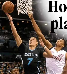  ?? USATODAY SPORTS ?? CHARLOTTE Hornets guard Jeremy Lin slips past Miami Heat center Hassan Whiteside during Game 3 of their quarterfin­al series.