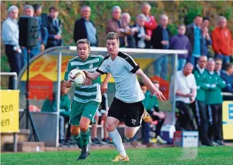  ?? FOTO: THOMAS WIECK ?? Auersmache­rs Spielertra­iner Philipp Weyers (links) verfolgt Brebachs Brice Moy. Im Saarlandli­ga-Derby vor knapp 700 Zuschauern dominierte­n beide Mannschaft­en eine Halbzeit lang.