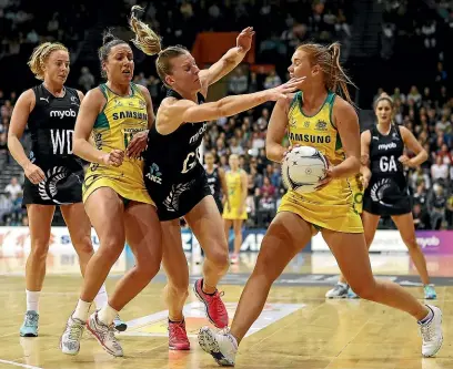  ?? GETTY IMAGES ?? Silver Ferns Katrina Grant defends against Australia’s Stephanie Wood during the third Constellat­ion Cup test in Hamilton on Sunday.