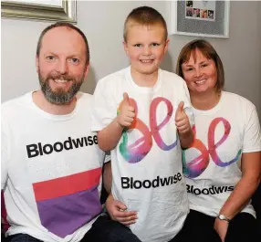  ??  ?? Thumbs up Joshua with dad Nigel and mum Jude 011116irwi­n_01