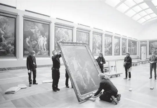  ?? DMITRY KOSTYUKOV/THE NEW YORK TIMES PHOTOS ?? Anthony van Dyck’s “Venus Asks Vulcan to Cast Arms for Her Son Aeneas” is moved by workers in January at the Louvre in Paris.