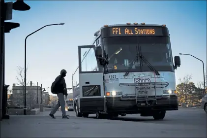  ?? Timothy Hurst / Staff Photograph­er ?? A rider boards an RTD bus at the 16th Street and Broadway stop on Tuesday in Boulder. The Boulder City Council at its Tuesday meeting heard an update on the changes that 2020 brought to the Regional Transporta­tion District and how they might affect residents.