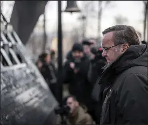  ?? (AP/Ukrainian Defence Ministry Press Office) ?? German Defense Minister Boris Pistorius pays his respects Tuesday at a memorial to people who died in clashes with security forces during the Revolution of Dignity at Independen­ce Square in Kyiv, Ukraine.