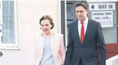  ?? — Reuters photo ?? Miliband leaves after voting with his wife Justine in Doncaster, northern England, Britain.