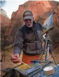  ??  ?? 2018 featured artist Bill Cramer works on a piece during a previous Zion National Park Plein Air Invitation­al.