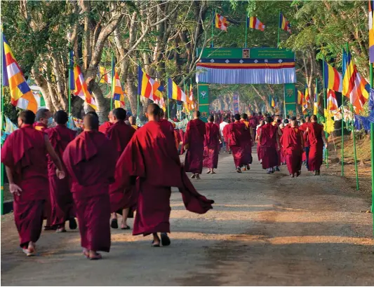  ??  ?? (Clockwise from facing page) Offerings at one of the monasterie­s in Mundgod; monks arrive from all around and indulge in merrymakin­g each time the Dalai Lama visits the town; with a total of 15,000 Tibetans, Mundgod is the largest monk settlement in the world