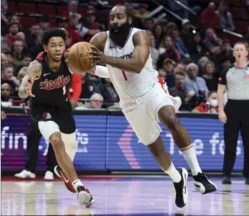  ?? PHOTOS: CRAIG MITCHELLDY­ER — THE ASSOCIATED PRESS ?? The Clippers' James Harden drives past Portland's Anfernee Simons during the first half of Wednesday's game.
