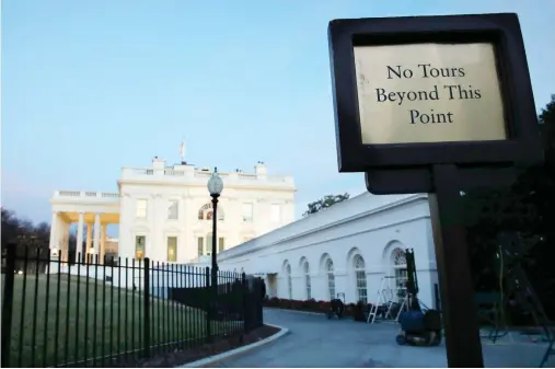  ??  ?? The White House is seen at sunset Saturday in Washington. Republican­s and Democrats showed no signs of ending their standoff over immigratio­n and spending as Americans awoke to the first day of a government shutdown and Congress staged a weekend...