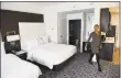  ?? Tyler Sizemore / Hearst Connecticu­t Media ?? Sales and Marketing Director Tina Mazzullo shows a double queen-bed studio at the new Marriott Residence Inn extended-stay hotel in downtown Stamford on Wednesday.