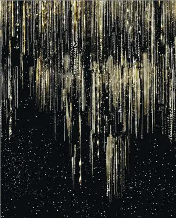  ?? ELLI POPP/KATJA BEHRE/THE ASSOCIATED PRESS ?? Golden Slumbers wallpaper sparkles in designer Katja Behre’s Elli Popp line. The metallic pattern on black background suggests shooting stars, or rain against a night sky.