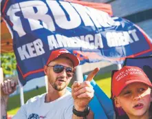  ?? AMANDA VOISARD/WASHINGTON POST ?? Zach Moushon and his son, Holden Moushon, 8, camp Wednesday with fellow Donald Trump supporters outside the BOK Center in Tulsa, Okla., days before the start of the official rally.