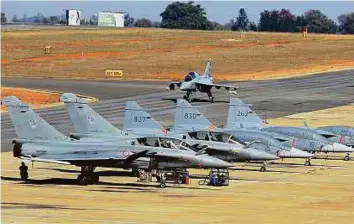  ?? PTI ?? A Tejas aircraft on the tarmac near parked fighter aircrafts prior to AERO India 2017 at Yelahanka Air Base in Bengaluru yesterday. It has been rejected by the Indian navy.