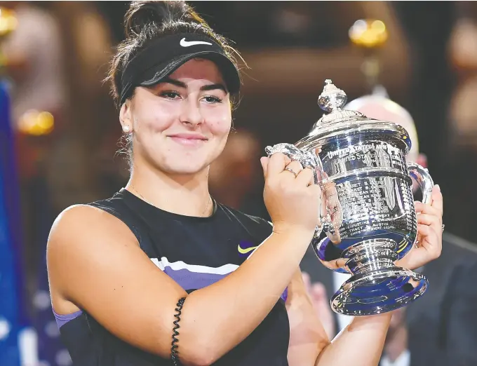  ?? Robert DEUTSCH / USA TODAY SPORTS FILES ?? Bianca Andreescu holds up the U.S. Open championsh­ip trophy after beating Serena Williams in the women’s singles final in front of a largely hostile crowd at Arthur Ashe Stadium in 2019. The Australian Open next week will be the Canadian tennis player’s first Grand Slam event since then.