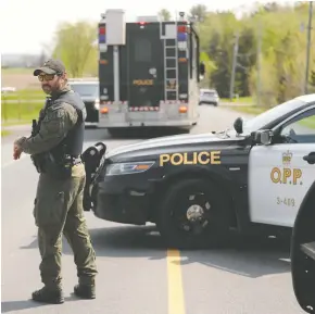  ?? JULIE OLIVER / POSTMEDIA NEWS ?? Police block off the area outside a home on Laval Street in Bourget, Ont., on Thursday, where OPP Sgt. Eric Mueller was fatally shot and two of his colleagues were injured.