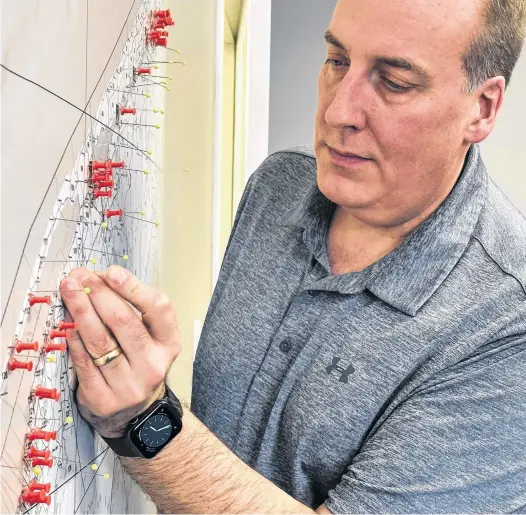  ?? TINA COMEAU ?? West Nova MP Chris d’Entremont adds another pin to a portion of a map of the West Nova riding in which he’s visited, attended events or had meetings with people to help track where he’s been and where he still needs to go to.